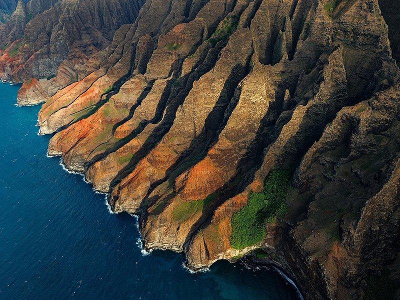 Ridges and valleys running down into the sea, seen from the air